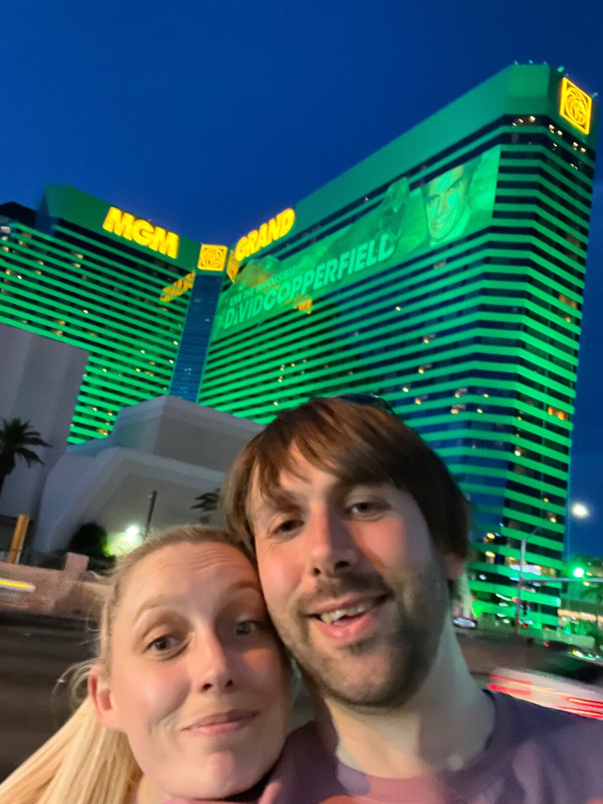 Will and Amie outside the illuminated MGM Grand hotel in Las Vegas